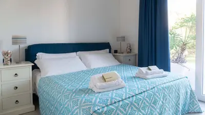 Letto o letti in una camera di Porto Corallo Seafront