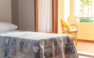Letto o letti in una camera di Casa Baddò, fronte spiaggia Air Con IUN R1866