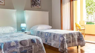 Letto o letti in una camera di Casa Baddò, fronte spiaggia Air Con IUN R1866