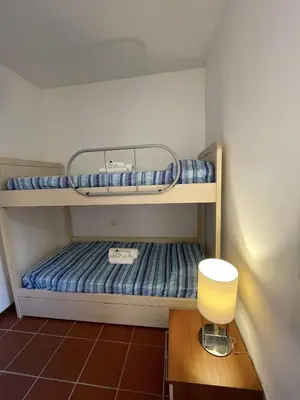 Letto o letti in una camera di Villetta con Giardino Punta Est