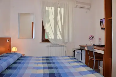 Letto o letti in una camera di Domo - Guest-House Il Nespolo Fiorito