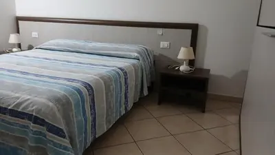 Letto o letti in una camera di Domo - Guest-House Il Nespolo Fiorito