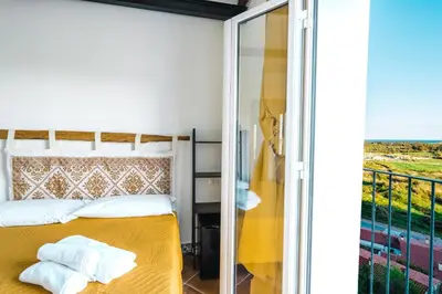 Letto o letti in una camera di CAMERA VISTA MARE CASA RAIMONDA Ammentos Posada