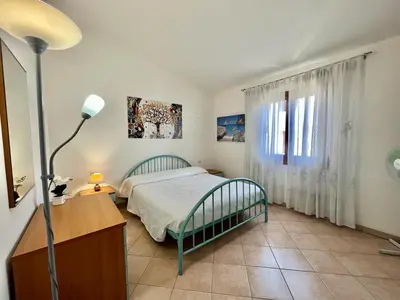 Letto o letti in una camera di Casa Vacanza Lu Riu
