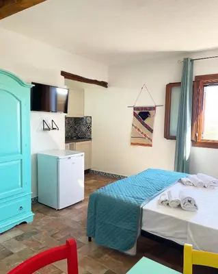 Letto o letti in una camera di LOFT CON USO CUCINA E TERRAZZO PANORAMICO - FORA E' MUROS II - Ammentos Posada