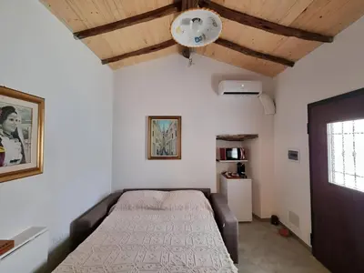 Letto o letti in una camera di La Casetta Sarda Centro Storico Spiagge vicine per ogni tipo di vacanza