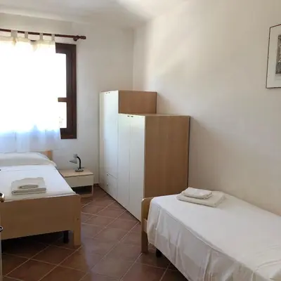 Letto o letti in una camera di Il Borgo Appartamenti by KasaVacanze