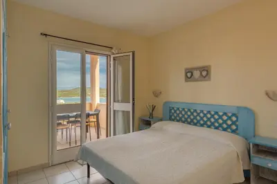 Letto o letti in una camera di ISA-Residence Baia de Bahas Golfo di Marinella