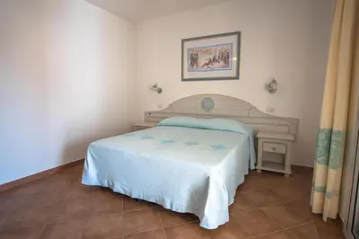 Letto o letti in una camera di Superb Le Residenze del Golfo di Orosei num2191