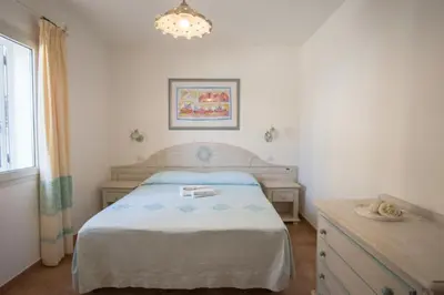 Letto o letti in una camera di Superb Le Residenze del Golfo di Orosei num2192