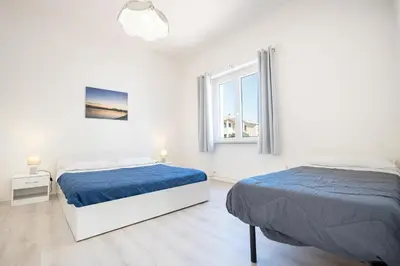 Letto o letti in una camera di Appartamento “Libeccio” a 300m dalla spiaggia