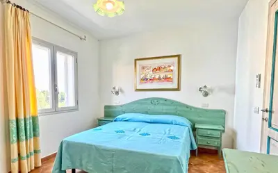 Letto o letti in una camera di Residence in Orosei apartments with air conditioning and private outdoor area