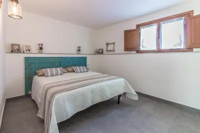 Letto o letti in una camera di Villa Cala di Luce - Teloni