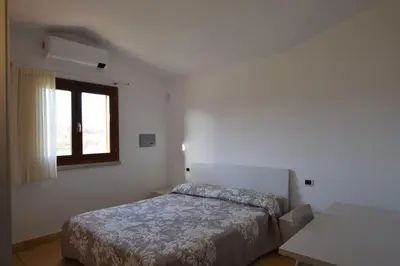 Letto o letti in una camera di Luisa Apartment In Budoni, Shared Pool