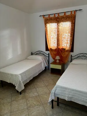 Letto o letti in una camera di Appartamento vista mare Tanaunella