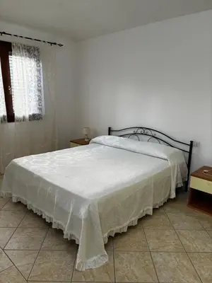 Letto o letti in una camera di Appartamento vista mare Tanaunella
