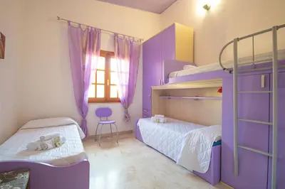 Letto o letti in una camera di Capo Comino 1