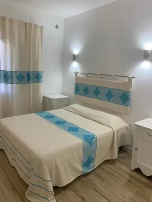 Letto o letti in una camera di Budoni Beach Apartments
