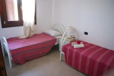 Letto o letti in una camera di Villette lu nibaru by BudoniAffitti
