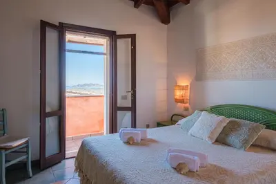 Letto o letti in una camera di Vista Mare-Isola Tavolara e Solarium Panoramico