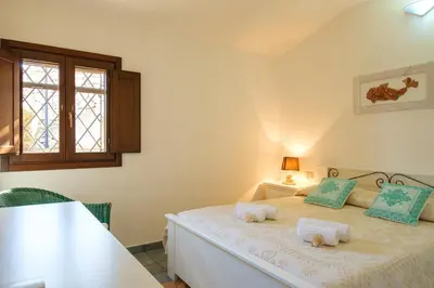 Letto o letti in una camera di [Incantevole Villetta]con Giardino e Vista mare