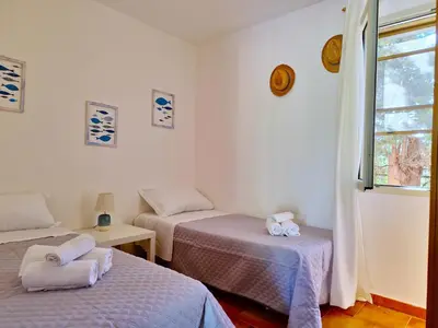 Letto o letti in una camera di La Parapepita - Villetta con giardino privato