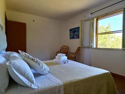 Letto o letti in una camera di La Parapepita - Villetta con giardino privato