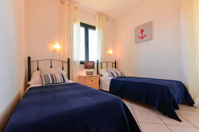 Letto o letti in una camera di Residence SardegnaSummer Li Cuppulati