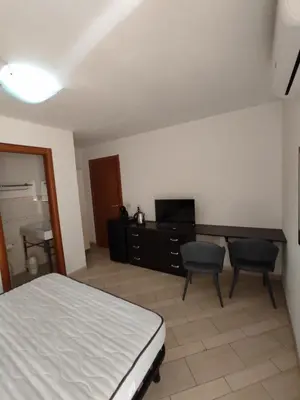 Letto o letti in una camera di MONOLOCALE WENGE'