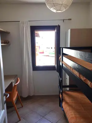 Letto o letti in una camera di Appartamento nel verde con vista su Tavolara