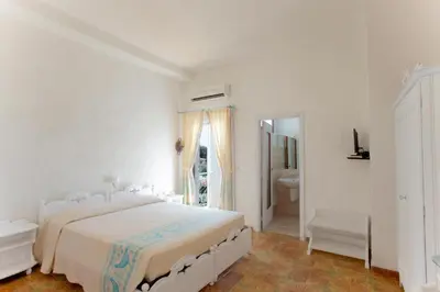 Letto o letti in una camera di HOTEL Al FARO , SPIAGGIA LA CINTA ,SAN TEODORO