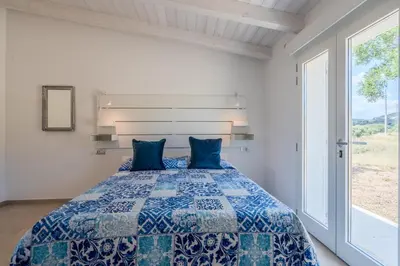 Letto o letti in una camera di Villa DEG Vista Mare San Teodoro Puntaldia