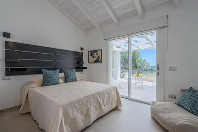 Letto o letti in una camera di Villa DEG Vista Mare San Teodoro Puntaldia