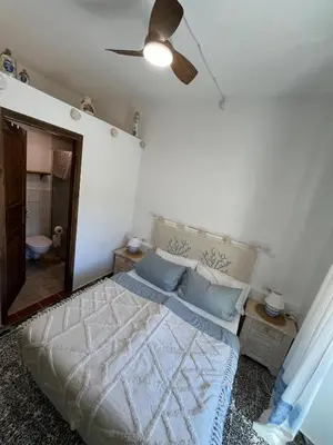 Letto o letti in una camera di B&B San Gavino