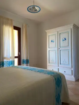 Letto o letti in una camera di Villa Ginevra a Lu Fraili - San Teodoro
