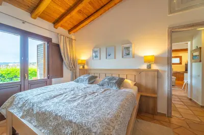 Letto o letti in una camera di Le Giuggiole di Punta Molara