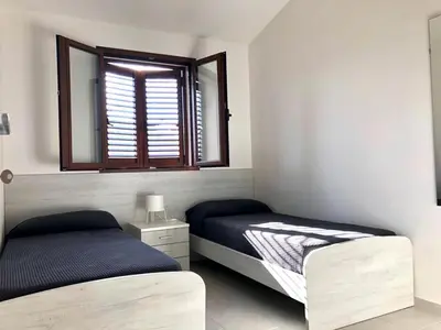 Letto o letti in una camera di La perla sul mare della Caletta