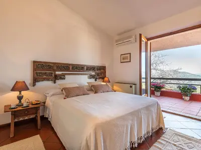 Letto o letti in una camera di Villa Billia Sardinia Domus