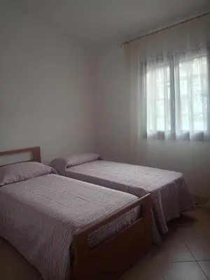 Letto o letti in una camera di San Teodoro Graziosa casa vacanza con parcheggio privato
