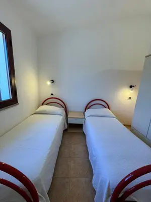 Letto o letti in una camera di Case vacanza Corallo - San Teodoro centro