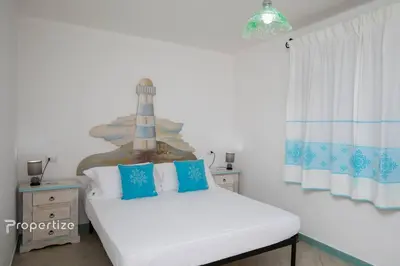 Letto o letti in una camera di Villa Azzurra by Propertize