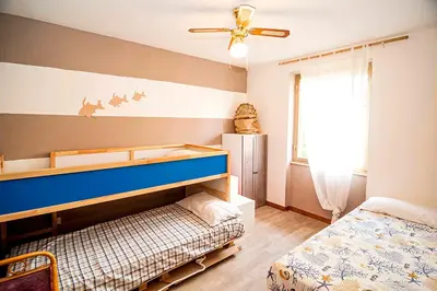 Letto o letti in una camera di Appartamento grande ed elegante, vicinissimo alla spiaggia e al porto