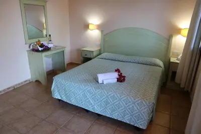 Letto o letti in una camera di Club Esse Cala Gonone