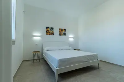 Letto o letti in una camera di Le Conchiglie Apartments with Pool by Wonderful Italy