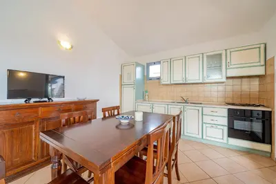 Cucina o angolo cottura di ISA-Residence with swimming-pool in Cala Girgolu, apartments with private outdoor area