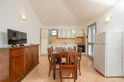 Cucina o angolo cottura di ISA-Residence with swimming-pool in Cala Girgolu, apartments with private outdoor area