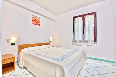 Letto o letti in una camera di Residence with swimming-pool in Ottiolu just 250 mt from the sea