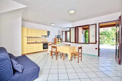 Cucina o angolo cottura di ISA-Residence with swimming-pool in Ottiolu just 250 mt from the sea, apartments with air conditioning and private outdoor area