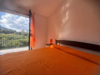 Letto o letti in una camera di fta-aga144p1 casa 4 posti vicino al mare Budoni