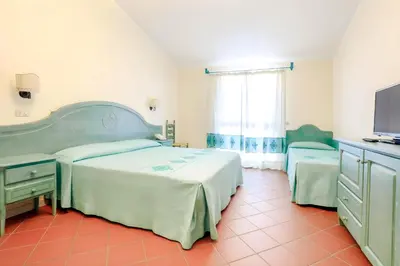 Letto o letti in una camera di Hotiday Golfo Aranci